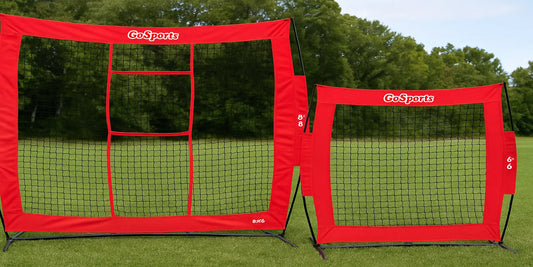 Two GoSports football throwing nets, sizes 8x8 and 6x6, with red frames and black mesh, set on a green grass field against a tree-lined backdrop.