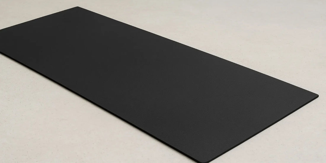 A black 72x36 exercise equipment mat with 6mm thickness placed on a light gym floor, highlighting its durable non-slip texture and sturdy build.
